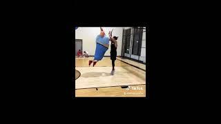 Fat guy dunks on basketball player 