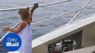 Hilarious moment rapper's daughter throws phone in the sea