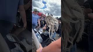 Lindsay Bercosky signs someone's tailgate with an angle grinder!