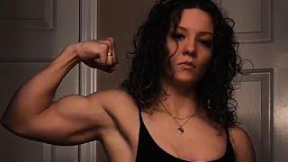 Beautiful muscle girl flexing big biceps