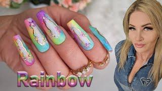 Vibrant Rainbow Nail Art with Delicate Floral Accents. Summer ombre nail art.