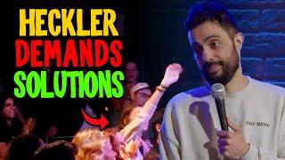 HECKLER DEMANDS SOLUTION TO ISRAEL/PALESTINE