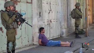 Israeli forces detain two Palestinian youths during clashes, in the West Bank city of Hebron