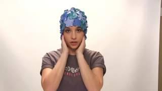 How to put on a swim cap without tearing it.