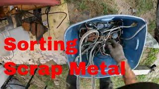 Sorting through the whole bucket of miscellaneous Scrap Metal from the last load