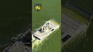 Ukrainian soldiers go fishing as they cross the river