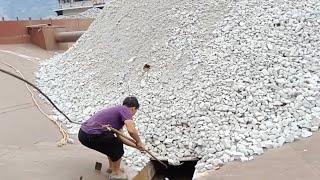 Barge unloading white limestone, natural sound of rock flow