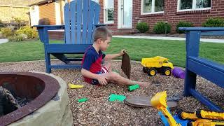 Five Year Old Playing with Construction Toys Outside