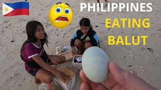 Kids Teach foreigner how to eat balut. White Beach, Moalboal. PHILIPPINES 2024.