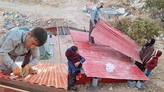 masterpiece of  nomadic lady:story of building dream roof with TheIron sheets of destroyed house