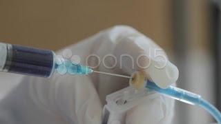 Injecting Blue Serum Into Iv (Hd). Stock Footage