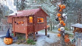 Halloween Celebration in a Wooden House in the Forest with Snow Falling