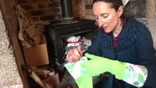 Cleaning the fireplace with rubber gloves