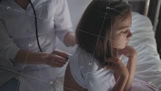 Attentive nurse listens breathing of a girl, using a phonendoscope