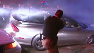 Cops Tv show Albuquerque New Mexico. Police chase and cop shatters passenger car window. (2000).