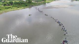 Caravan of migrants crosses river from Guatemala to Mexico