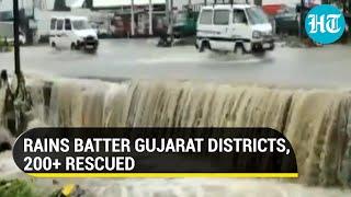 Road turns into waterfall as heavy rains cause flooding in Gujarat; IAF, Navy help NDRF