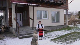 Woman cooks traditional food for the holidays in a Romanian Mountain Village.