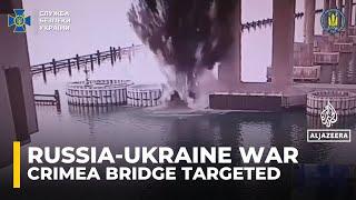 Ukraine strikes Crimea bridge, a key route for Russian military supplies in the war