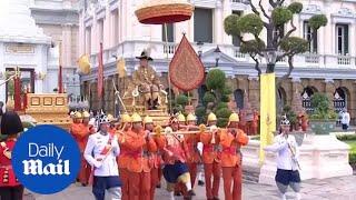 King of Thailand carried to Temple of the Emerald Buddha on a throne