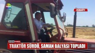 Traktör sürdü, saman balyası topladı