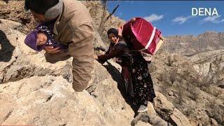 A mother with her baby in a cradle on a difficult path. Migration of nomads