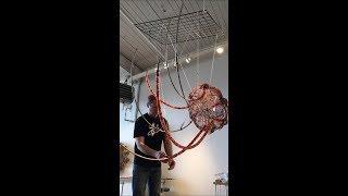 Glass artist Kait Rhoads creating a giant jellyfish chandelier out of steel and murrine