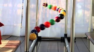 A simple demo of order and chaos (and order again) - Home made Pendulum Wave with 15 billiard balls