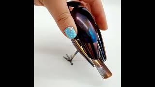 A Heat-painted Fork Bird hand-crafted from recycled cutlery.