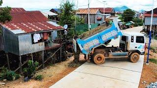 Drop the dirt in front of the home adjacent to the road to bury the pillars in front of the steps.