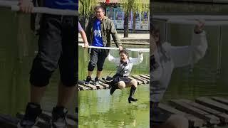 Wet heels boots and short skirts on suspension bridgefall into water