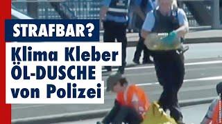 Klima-Kleber Öl-Dusche von Polizistin. Ist das strafbar?