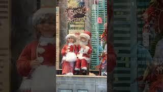 Christmas Charms: Santa and Doll Duo Delight in NYC Store Window