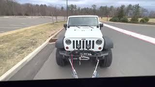 Flat towing Jeep behind RV.