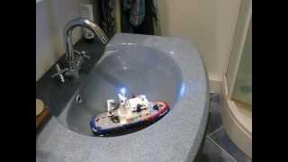 Action minitug with Kitchen Rudder in bathroom sink