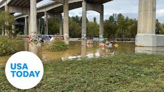 Debris, flooding fills Asheville's River Arts District after Helene | USA TODAY