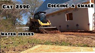 Digging a small swale with my Cat 259D skid steer! Building a Cottage.