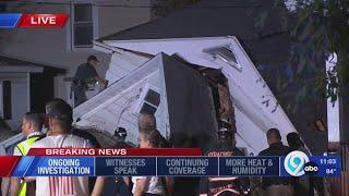 Crews working late at the site of a house collapse on Carbon Street in Syracuse