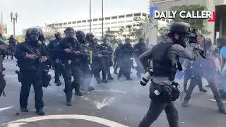 Protester in LA F's around with riot cops, immediately finds out when the projectiles start flying