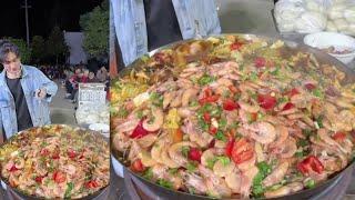 A Handsome Chinese Guy Cook Free Meals / Shrimps Noodles Food for the old on the Street in a Village