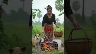 Braving the Storm Cambodian Woman Roasts Meat in Windy Rice Fields with Her Animals