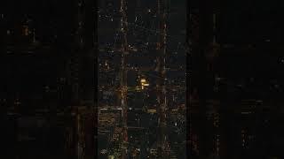 Vertical aerial view of Manhattan, New York City, showcasing streets at night in slow motion. The