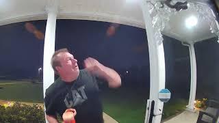 Snake Hanging From Front Door Bites Man on Head - 1434649-1