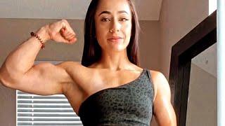 Beautiful muscular woman flexing muscles