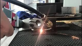 Hand held laser welding machine with wire feeder for carbon steel welding.