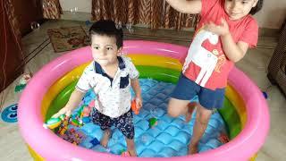 Aru and Avi play with bubbles in an inflatable pool. Fun kids' video!