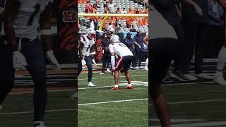 Christian Gonzalez helping Ja'Lynn Polk warmup for his NFL debut