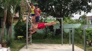 Kids Stand on Man Doing Flagpole Pose