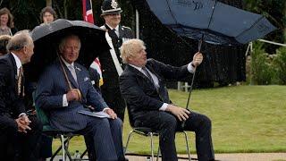 Boris Johnson struggles with umbrella at police memorial unveiling