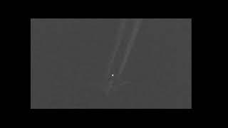 Luminous veriform UFO flies over chem-trail jet - Captured by John Graf